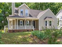 Charming two-story home with a welcoming front porch and well-maintained landscaping at 2324 Dahlgreen Rd, Raleigh, NC 27615
