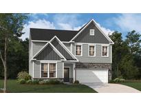 Beautiful new two story home with gray siding, stone accents, manicured lawn, and a two-car garage at 234 Macon Lake Drive # 39, Apex, NC 27523
