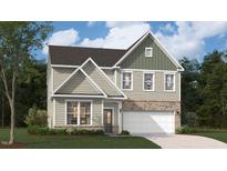 Two-story home boasts a modern design, blending brick and siding for a stylish, eye-catching curb appeal at 254 Macon Lake Drive # 34, Apex, NC 27523