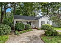Charming single story home with a concrete driveway and a well maintained, manicured front yard and mature trees at 2629 Hiking Trl, Raleigh, NC 27615