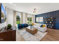 Bright living room with a modern chandelier, stylish furniture, and large windows offering scenic views at 2808 Kempthorne Rd # 61, Cary, NC 27519