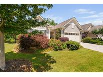 Charming home with a manicured lawn and colorful flowerbeds enhancing its curb appeal at 323 Rosedale Creek Dr, Durham, NC 27703