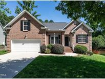 Beautiful one-story brick home with a manicured lawn and a two-car garage at 3709 Andoversford Ct, Wake Forest, NC 27587