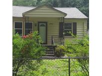 Charming home exterior with welcoming front porch, tidy yard, and classic design elements at 4112 Forrest Ave, Efland, NC 27243