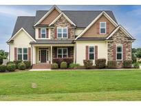 Charming two-story home with a well-maintained lawn and inviting curb appeal at 5400 Falconton Ln, Raleigh, NC 27610