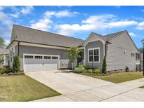 Charming single-Gathering home with a two-car garage and a well-manicured lawn in a residential neighborhood at 704 Haven Peak Ln, Wake Forest, NC 27587