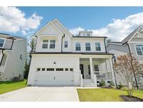 Charming new construction home featuring a two-car garage, covered porch, and manicured lawn at 772 Mirkwood Ave, Apex, NC 27523