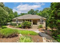 Charming brick home with well-manicured lawn and mature trees, perfect for curb appeal at 101 Cardiff Pl, Chapel Hill, NC 27516