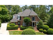 Charming brick home with lush, manicured landscaping and a welcoming front entrance at 104 San Sophia Dr, Chapel Hill, NC 27514