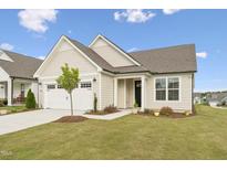 Beautifully landscaped home features a charming front yard and attached two-car garage at 1625 Plover Cir, Fuquay Varina, NC 27526