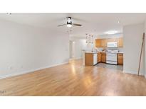 Bright open-concept living area featuring a well-equipped kitchen with modern appliances and a breakfast bar at 1851 Trailwood Heights Ln, Raleigh, NC 27603