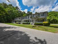 Charming townhomes with classic architectural details, inviting front porch and lush landscaping at 225 Douglas St, Holly Springs, NC 27540
