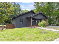Charming single-story home with a well-maintained lawn and inviting front porch at 2318 E Main St, Durham, NC 27703
