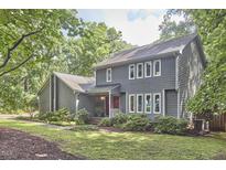 Charming two-story home featuring a well-manicured lawn and lush landscaping adding to its curb appeal at 2334 Dawn Trl, Durham, NC 27712