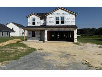 New construction home featuring a two-story layout, covered entrance, and an attached two-car garage at 29 Chloe Ct, Selma, NC 27576