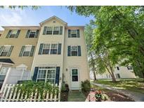 Traditional two-story townhouse featuring green shutters, a white front door, and well-maintained landscaping at 2920 Barrymore St # 106, Raleigh, NC 27603