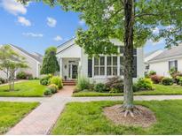 Charming home featuring a well-maintained lawn, lush landscaping and a brick walkway at 31 W Madison, Pittsboro, NC 27312