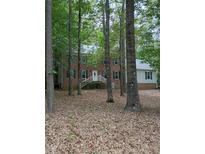 Charming brick home with a welcoming front entrance and lush greenery, perfect for serene living at 3300 Barnsley Ln, Raleigh, NC 27604
