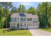 Charming two-story home with a combination stone and siding exterior and well-manicured lawn at 40 Otter Ct, Youngsville, NC 27596