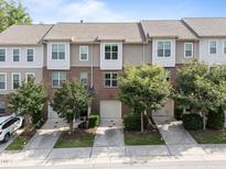 A row of two-story townhomes with attached garages and well-maintained landscaping at 4124 Sykes St, Cary, NC 27519