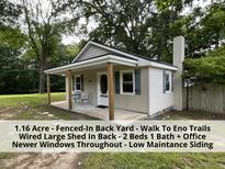 Charming home boasts a cozy front porch and well-maintained vinyl siding at 4720 Rivermont Rd, Durham, NC 27712