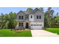 Beautiful two-story home featuring gray and white siding, a covered porch, and a spacious two-car garage at 4824 Bristol Meadow Dr, Raleigh, NC 27603