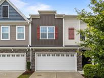 Charming townhouse featuring stone accents, a two-car garage, and complementary neutral siding at 640 Barneswyck Dr, Fuquay Varina, NC 27526