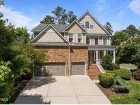 Beautiful two-story home with stone accents, attached two-car garage and manicured lawn at 705 Harkness Cir, Durham, NC 27705