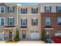 Charming townhome featuring a one-car garage and unique architectural details at 732 Suffield Way, Cary, NC 27519