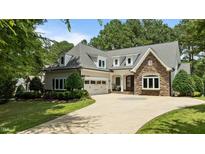 Charming two-story home with stone accents, manicured lawn, and circular driveway at 763 Heritage Arbor Dr, Wake Forest, NC 27587