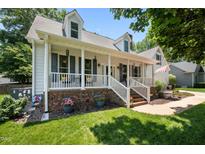 Beautiful home with inviting porch and well-maintained landscaping at 907 Stuart Dr, Mebane, NC 27302