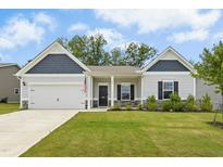 Charming single-Gathering home with a well-manicured lawn, attached garage, and inviting entrance at 107 Altair Ln, Sanford, NC 27330