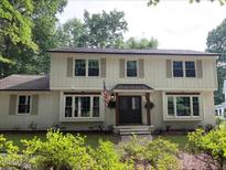 Charming two-story home featuring a welcoming entrance, neutral shutters, and mature landscaping at 1300 Seabrook Ave, Cary, NC 27511