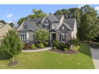 Beautiful two-story home featuring a stone and siding exterior with a landscaped front yard at 1325 Mackinaw Dr, Wake Forest, NC 27587