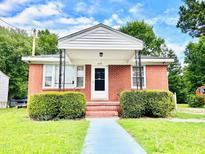 Charming single-story red brick home featuring a cozy front porch and well-maintained landscaping at 1337 Maple St, Rocky Mount, NC 27803