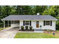 Charming single-story home with white brick, black shutters, and a well-manicured lawn at 1713 Elder Ct, Burlington, NC 27215