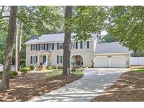 Charming two-story home featuring blue shutters, a two-car garage, and a well-manicured lawn at 1913 Fawndale Dr, Raleigh, NC 27612