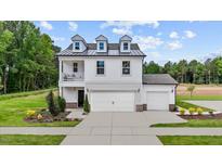 Charming two-story home featuring a white exterior, dormer windows, and a well-manicured lawn at 215 Faith Avenue, Sanford, NC 27330