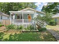 Charming home featuring a covered front porch and beautiful landscaping at 2322 Stroller Ave, Durham, NC 27705
