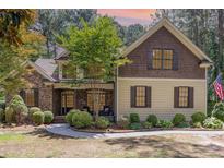 Charming home with stone and siding exterior, manicured lawn, and inviting front porch at 240 Oak Grove Church Rd, Youngsville, NC 27596