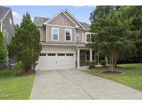 Charming two-story home featuring a two-car garage and well-manicured front yard at 2904 Britmass Dr, Raleigh, NC 27616