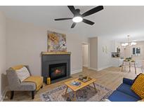 Comfortable living room featuring a fireplace, ceiling fan, and modern furnishings at 308 Greenwood Dr, Durham, NC 27704