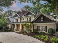 Stately two-story home featuring manicured landscaping, elegant columns, and a welcoming front porch at 3324 Thomas Rd, Raleigh, NC 27607