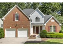 Beautiful two-story brick home with an attached two-car garage and well-manicured landscaping at 4619 Regency Dr, Durham, NC 27713