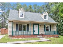 Charming home featuring a cozy front porch and dormer windows at 4709 Tyne Dr, Durham, NC 27703