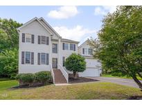 Charming two-story home featuring white siding, black shutters, and a well-manicured lawn at 5308 Bentgrass Dr, Raleigh, NC 27610