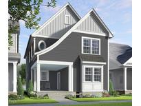 Charming two-story home with gray siding, a covered porch, and beautifully landscaped front yard at 536 Folk Song Way, Wendell, NC 27591