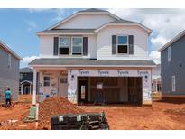 New construction of a two-story home featuring an unfinished front yard and an attached two-car garage at 644 Red River Dr, Garner, NC 27529