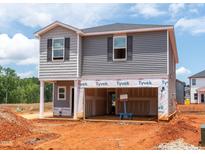 New home construction shows the two-story elevation with gray siding and two-car garage ready for finishing touches at 648 Red River Dr, Garner, NC 27529