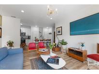 Bright living room featuring modern decor and a seamless flow into the kitchen area at 800 Savannah Ridge Rd # 109, Holly Springs, NC 27540